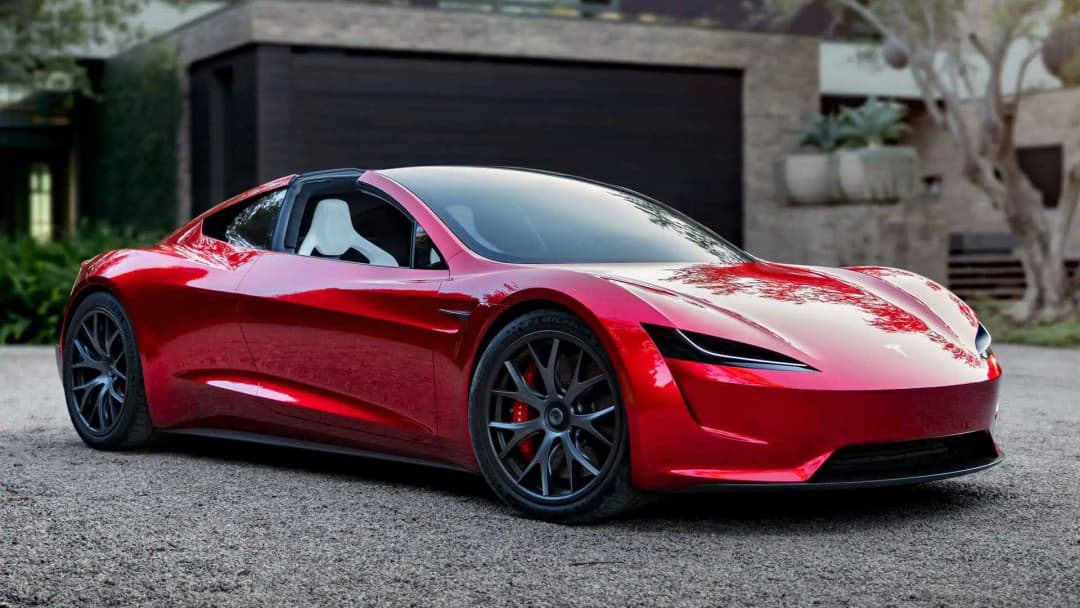 Red second-generation Tesla Roadster prototype parked in a driveway, front three-quarter view