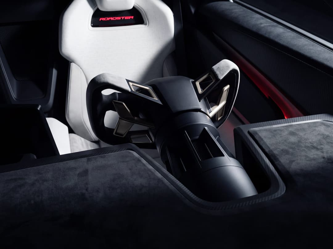 Tesla Roadster bucket seat with Roadster logo and steer-by-wire steering wheel